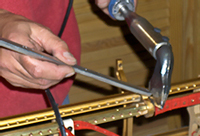 Tim Hendy Pianos workshop, new Steinway action rail soldered into position
